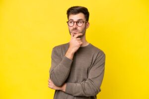 Young man wearing concerned, thoughtful expression