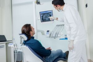 Dentist and patient reviewing X-ray together