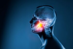Digital X-ray image of man’s head, with his jaw joint highlighted 