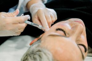 Woman receiving dermal filler injection