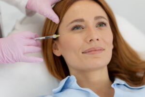 Woman relaxing while receiving dermal filler injection