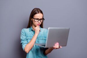 Woman using her laptop to research oral surgeons in her area