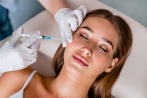 Woman relaxing while she receives cosmetic injection 